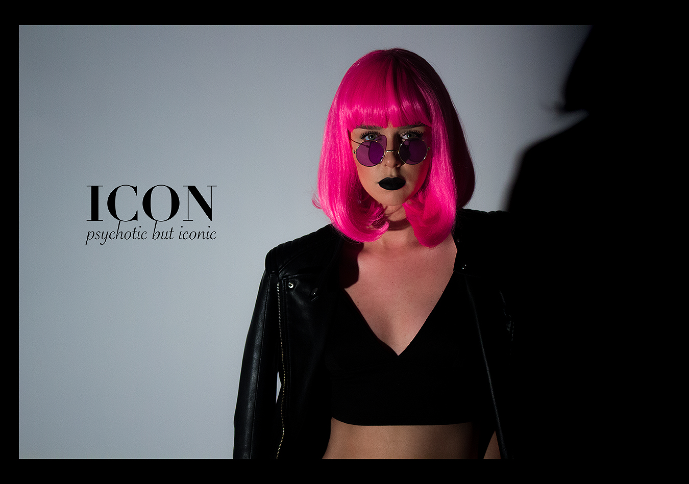RIA_VAIDYA_FASHION_BRAND_PHOTOGRAPHY_ICON_CLOTHING_LINE_GIRL_WOMAN_MONOCHROME_MINIMALIST_CLASSIC_CHIC_BLACK_WIG_HIGH_SUNGLASSES_COLOR_HAIR_PINK_EYES_EYELASHES_STARE_HORIZONTAL_LANDSCAPE_CROP_TOP_LEATHER_JACKET