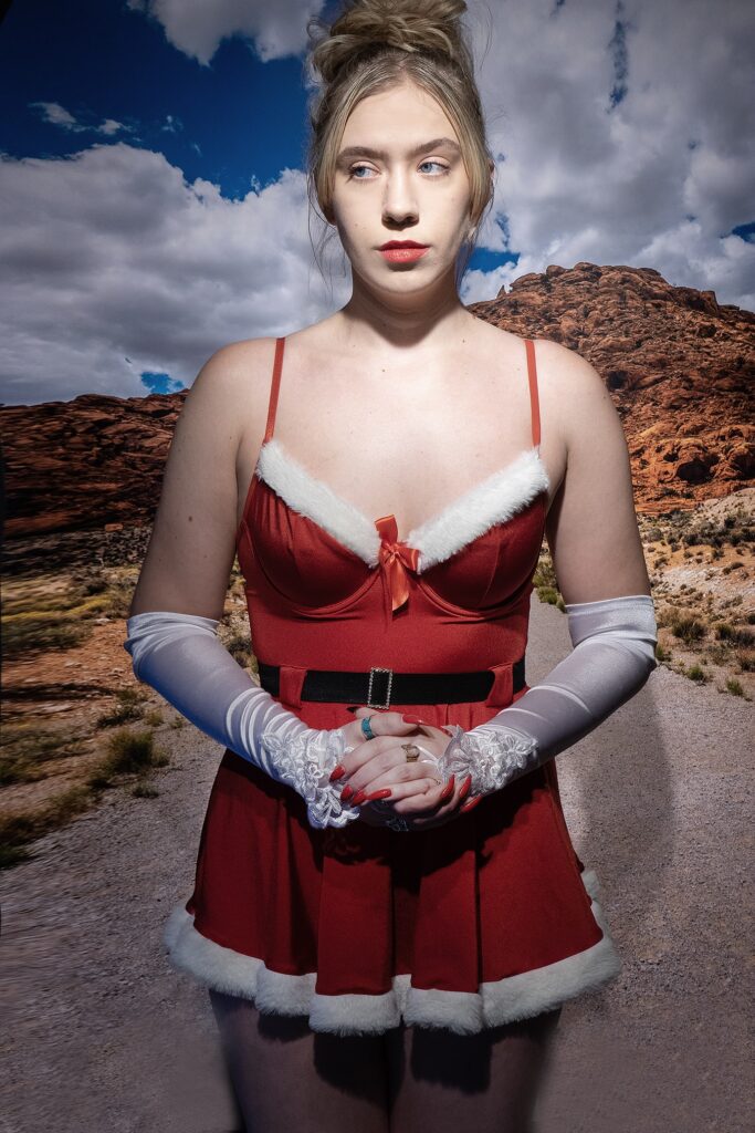 woman in the desert looking lonely wearing a Santa suit